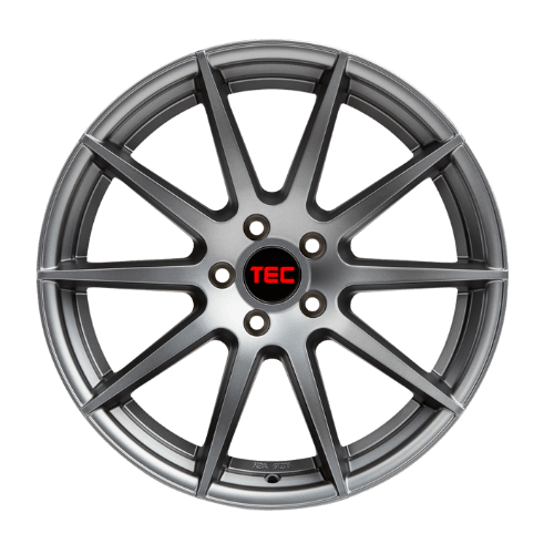 Graue Leichtmetallfelge mit Mehrspeichendesign und schwarzer Nabenkappe, auf der rote Buchstaben TEC auf weißem Grund stehen